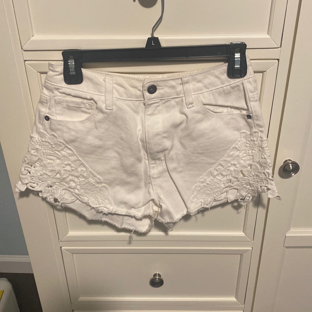 White jean shorts with lace detail on side